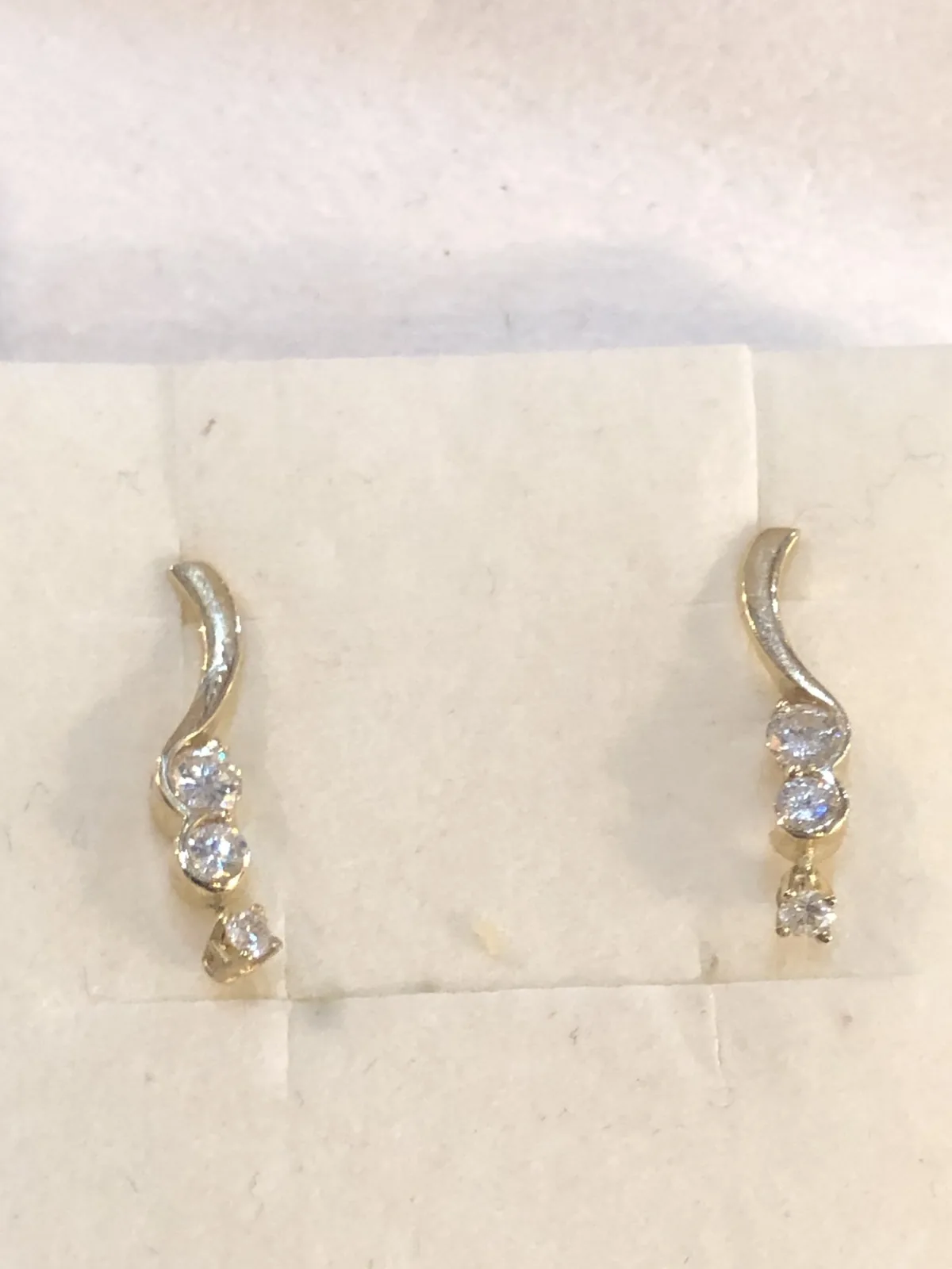 Small diamond drop earrings on a card